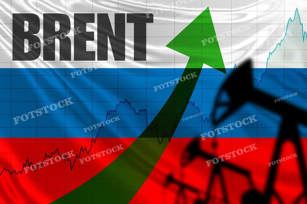 На фотографии изображен флаг России с наложенным на него словом "BRENT", графиком с восходящей тенденцией цен и силуэтом нефтяной вышки. Зеленая стрелка, направленная вверх, указывает на рост. Эта визуализация может использоваться для обсуждения цен на сорт нефти Brent, которая является международным бенчмарком, а также для иллюстрации экономического положения или тенденций на рынке энергоносителей в России.